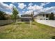 Spacious backyard showcasing a well-maintained lawn, soccer net, and secure fencing at 15716 Sweet Lemon Way, Winter Garden, FL 34787