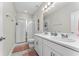 Bathroom featuring a double vanity, a glass-enclosed shower, and neutral-toned tiles at 15716 Sweet Lemon Way, Winter Garden, FL 34787