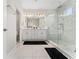 Luxurious bathroom with double vanity, marble floors, and glass shower at 15716 Sweet Lemon Way, Winter Garden, FL 34787