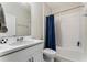 Bathroom featuring white vanity, shower and tub combo with blue curtain at 15716 Sweet Lemon Way, Winter Garden, FL 34787