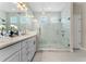 Luxurious bathroom with double vanity, marble floors, and glass shower at 15716 Sweet Lemon Way, Winter Garden, FL 34787