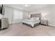 Bright bedroom with plush carpet, and a king bed with elegant gray headboard at 15716 Sweet Lemon Way, Winter Garden, FL 34787