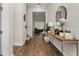 Elegant entryway featuring wood floors and a stylish console table at 15716 Sweet Lemon Way, Winter Garden, FL 34787