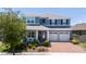 Charming two-story home with a well-manicured lawn and brick driveway at 15716 Sweet Lemon Way, Winter Garden, FL 34787