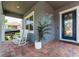 Inviting front porch with rocking chairs and stylish entrance, adding curb appeal at 15716 Sweet Lemon Way, Winter Garden, FL 34787