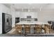 Spacious kitchen with stainless steel appliances, a large island with barstool seating, and modern lighting fixtures at 15716 Sweet Lemon Way, Winter Garden, FL 34787