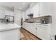 Sleek white kitchen featuring stainless appliances and tile backsplash at 15716 Sweet Lemon Way, Winter Garden, FL 34787