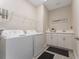 Laundry room featuring white washer and dryer, utility sink, and storage at 15716 Sweet Lemon Way, Winter Garden, FL 34787