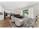 Open-concept living room with a gray sofa that offers great natural light at 15716 Sweet Lemon Way, Winter Garden, FL 34787