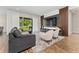 Modern living room with a plush gray sofa and a view of the backyard at 15716 Sweet Lemon Way, Winter Garden, FL 34787