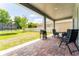 Covered patio with brick pavers, dining table, and outdoor grill at 15716 Sweet Lemon Way, Winter Garden, FL 34787