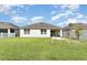 Expansive backyard featuring a well-maintained lawn and white fencing, perfect for outdoor activities and privacy at 1864 Green Dragon Dr, St Cloud, FL 34771
