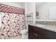 Bright bathroom featuring a decorative shower curtain and granite countertops at 1864 Green Dragon Dr, St Cloud, FL 34771