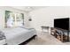 Cozy bedroom features a ceiling fan, window and neutral decor at 1864 Green Dragon Dr, St Cloud, FL 34771