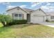 Inviting home with a lush lawn, a two-car garage, and beautiful curb appeal at 1864 Green Dragon Dr, St Cloud, FL 34771