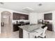 Modern kitchen featuring granite countertops, dark cabinetry, and a breakfast bar at 1864 Green Dragon Dr, St Cloud, FL 34771
