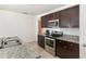 Well-equipped kitchen features stainless steel appliances, granite countertops, and dark wood cabinets at 1864 Green Dragon Dr, St Cloud, FL 34771