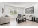 Bright living room with neutral decor, tile flooring, and a large window at 1864 Green Dragon Dr, St Cloud, FL 34771