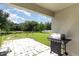 Outdoor patio featuring a grill and view of a lush, green backyard at 1864 Green Dragon Dr, St Cloud, FL 34771