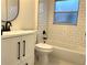 Bright bathroom features white subway tiles, dark fixtures, and modern vanity at 2118 Donegan Pl, Orlando, FL 32826