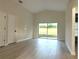 Spacious bedroom with laminate wood flooring, sliding glass door to the backyard at 2118 Donegan Pl, Orlando, FL 32826