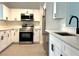 This stylish kitchen boasts stainless steel appliances and sleek white cabinetry for a contemporary feel at 2118 Donegan Pl, Orlando, FL 32826