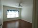Cozy bedroom featuring laminate floors, ceiling fan, and window with curtains at 2406 Grand Central Pkwy # 14, Orlando, FL 32839