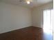 Spacious bedroom with wood floors, large windows with verticals, and a ceiling fan at 2406 Grand Central Pkwy # 14, Orlando, FL 32839