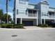 Gray two-story townhome with drive-under garage and screened balcony at 2406 Grand Central Pkwy # 14, Orlando, FL 32839