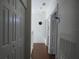 Upstairs hallway with three closets and wood floors at 2406 Grand Central Pkwy # 14, Orlando, FL 32839