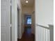 Hallway featuring wood floors with white walls connecting bedrooms at 2406 Grand Central Pkwy # 14, Orlando, FL 32839