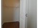 Walk-in closet includes white door, wooden floors, and wire shelving at 2406 Grand Central Pkwy # 14, Orlando, FL 32839