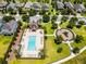 Aerial view of a community pool and playground, with lounge chairs and green spaces in a residential neighborhood at 251 Domus Ln, Casselberry, FL 32707