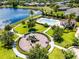 Aerial view of a community playground and pool area with a lake nearby, offering outdoor recreation for residents at 251 Domus Ln, Casselberry, FL 32707
