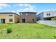 The backyard features green grass and a sliding glass door at 251 Domus Ln, Casselberry, FL 32707