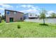 The backyard features green grass and a white fence at 251 Domus Ln, Casselberry, FL 32707