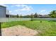 Large backyard with green grass and a white fence at 251 Domus Ln, Casselberry, FL 32707