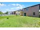 The backyard features green grass and other houses at 251 Domus Ln, Casselberry, FL 32707