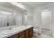 Bright bathroom featuring double sinks, walk-in shower, and a separate closet for ample storage space at 251 Domus Ln, Casselberry, FL 32707