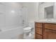 Bathroom featuring a bathtub and shower, toilet and vanity with wood cabinets at 251 Domus Ln, Casselberry, FL 32707