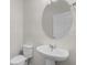Bathroom featuring a pedestal sink, toilet, and oval mirror at 251 Domus Ln, Casselberry, FL 32707