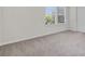 Bedroom featuring carpet floors, neutral walls, two windows and a door at 251 Domus Ln, Casselberry, FL 32707
