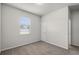 Cozy carpeted bedroom with a window and a door at 251 Domus Ln, Casselberry, FL 32707