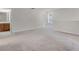 Open bedroom leading to a bathroom, featuring neutral carpet and abundant space at 251 Domus Ln, Casselberry, FL 32707