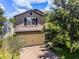 Two-story home with two-car garage, complemented by a brick driveway, mature trees and well kept landscaping at 251 Domus Ln, Casselberry, FL 32707