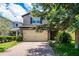 Charming two-story home with a two car garage and brick paved driveway and lush landscaping at 251 Domus Ln, Casselberry, FL 32707