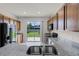 Kitchen featuring granite counters, stainless steel appliances, wood cabinets, and a sliding door to backyard at 251 Domus Ln, Casselberry, FL 32707