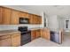 Kitchen features stainless steel appliances, granite counters, wood cabinets, and modern lighting at 251 Domus Ln, Casselberry, FL 32707