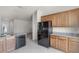 Open concept kitchen with stainless steel appliances, granite counters, and modern wood cabinets at 251 Domus Ln, Casselberry, FL 32707