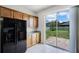Bright kitchen featuring stainless steel appliances, wood cabinets, and sliding doors to backyard at 251 Domus Ln, Casselberry, FL 32707